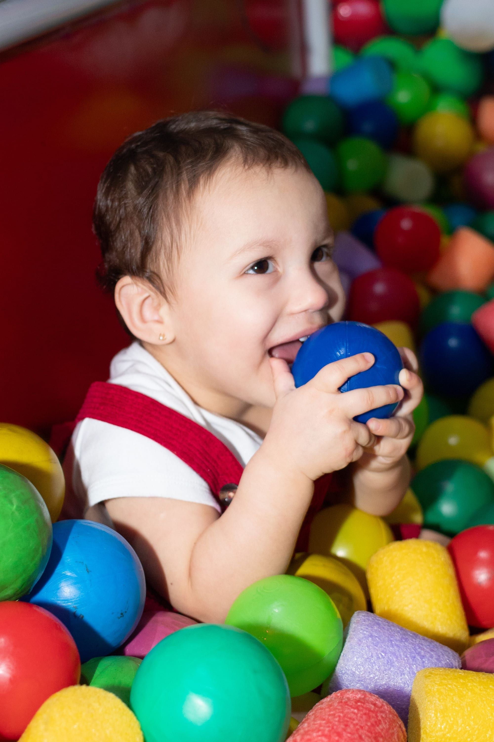 Toddler smiling in a ball pit