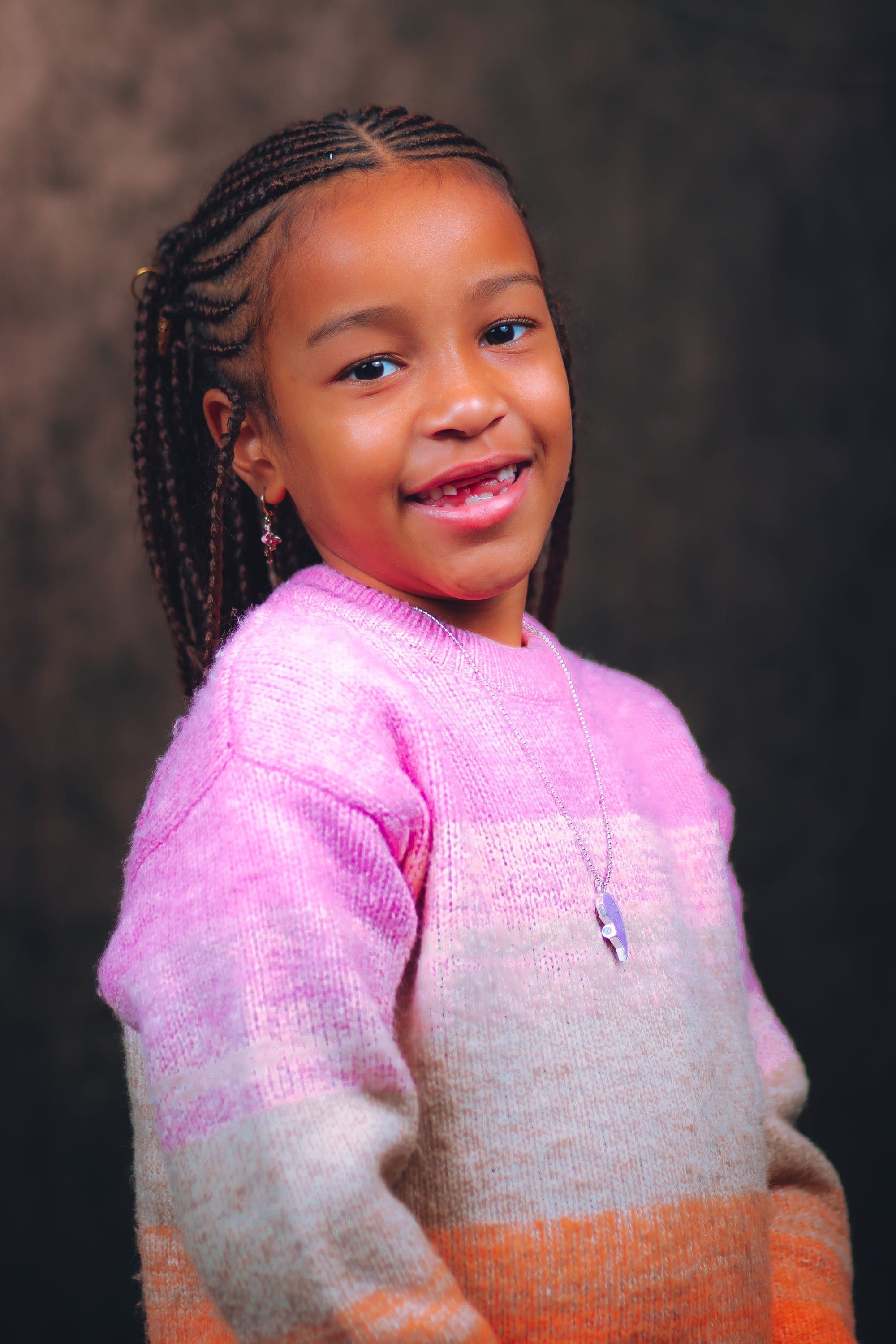 Smiling girl in a pink striped sweater
