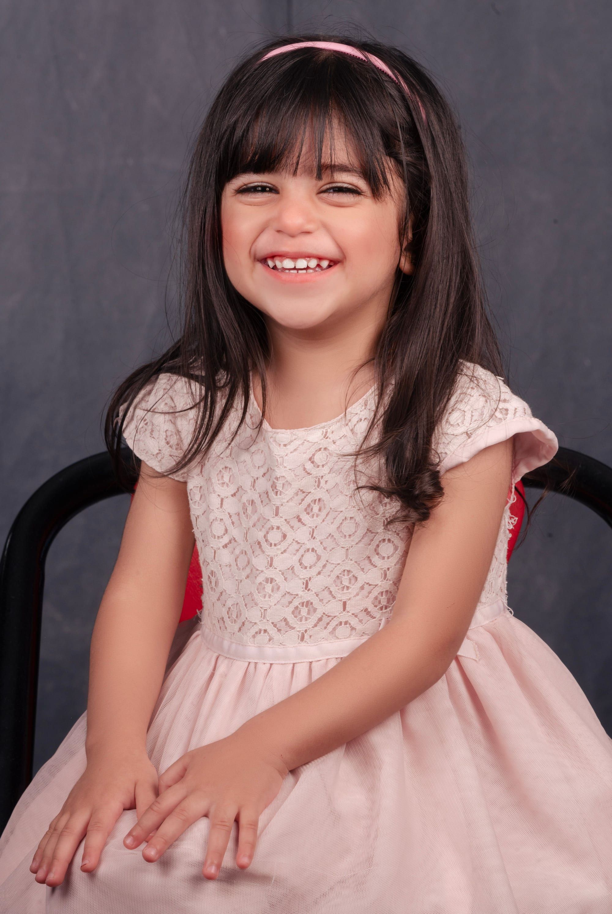 Laughing girl in a pink dress