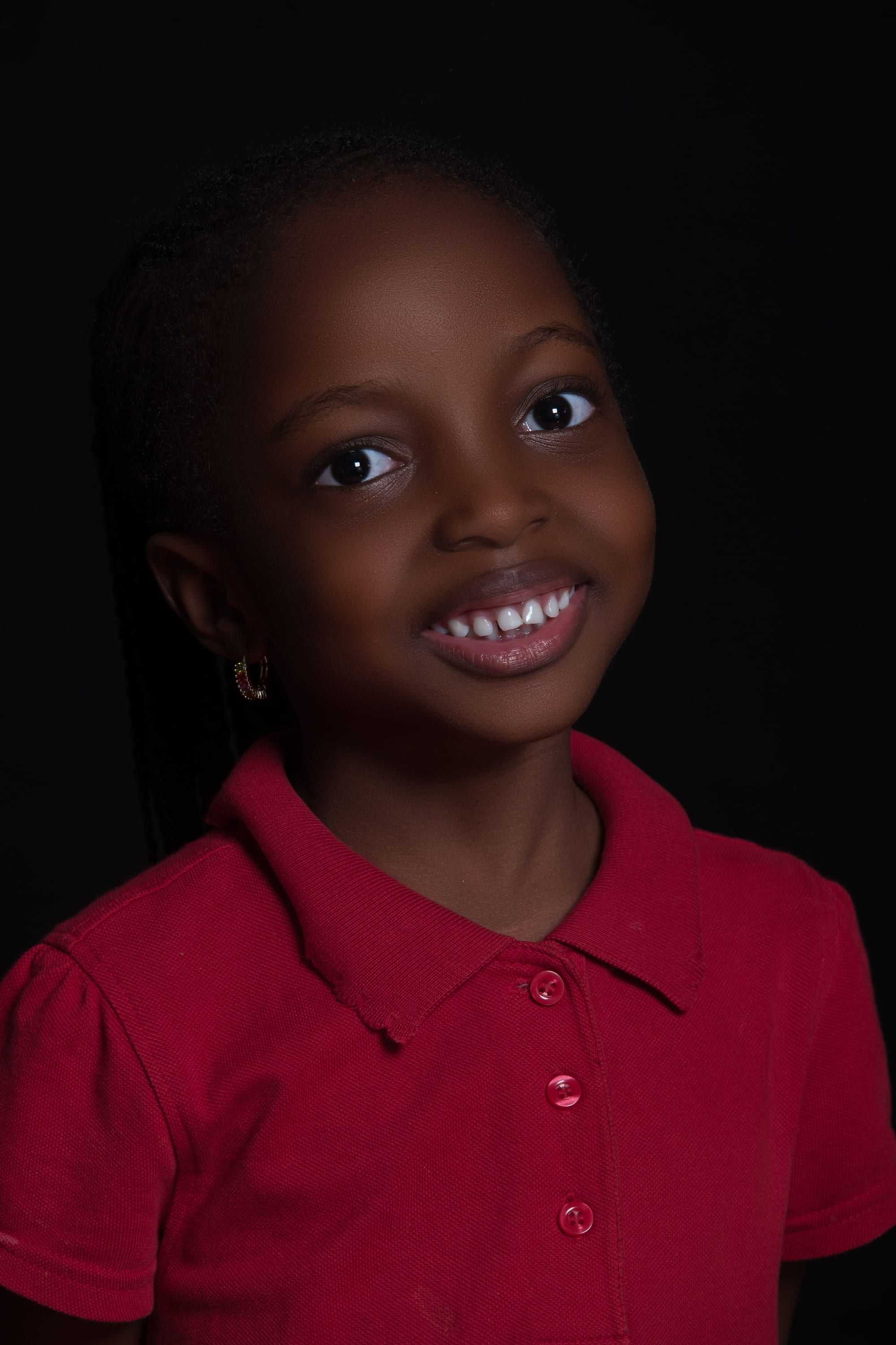 Smiling girl in a red polo